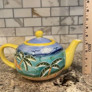 Adorable Teapot with tropical palm tree and lighthouse motif.